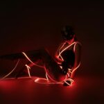 photograph of a woman posing with red led lights