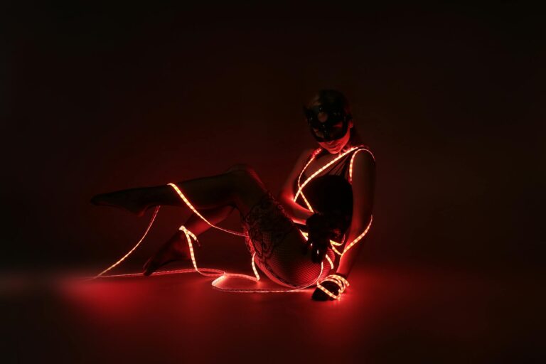 photograph of a woman posing with red led lights