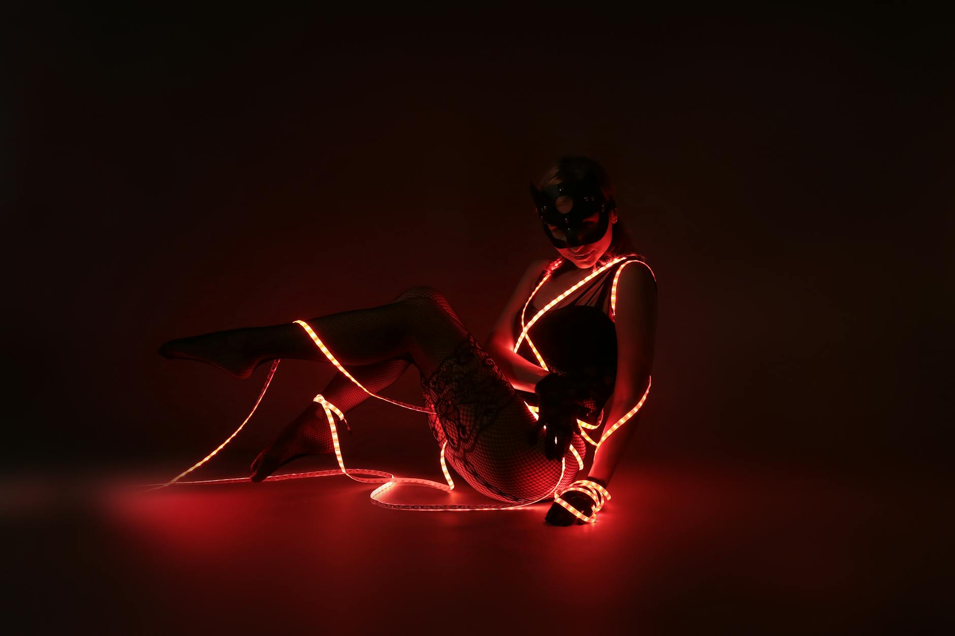 photograph of a woman posing with red led lights